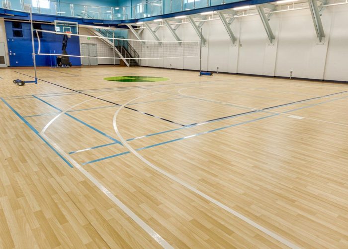 athletic-vinyl-padded-roll-court-install-chestnut-wheat